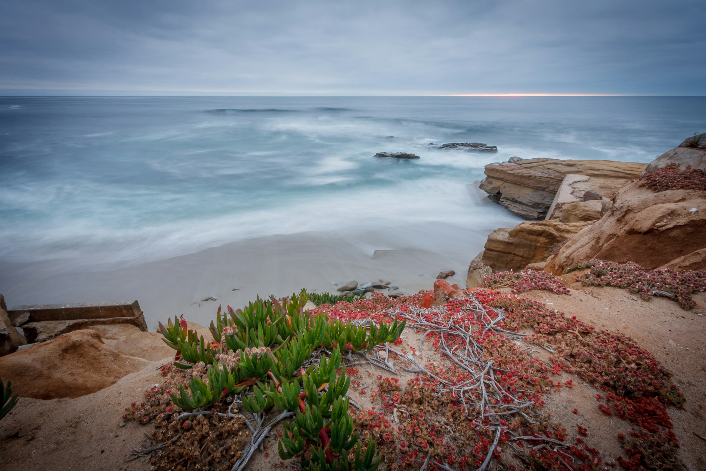 Pacific water moving around the sandstone cliffs at La Jolla Cove